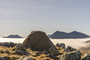 Wonderful camping scene with a tent above a cloud inversion weather in Snowdonia, UK