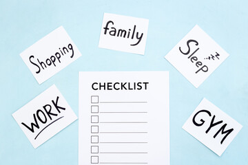 Checklist and many paper cards with hand drawing of different life activities, top view. Life balance and planning concept.