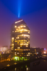 Skyscraper in Gothenburg surrounded by mist during evening light in Sweden
