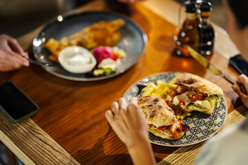 Friends enjoying lunch together at a restaurant table