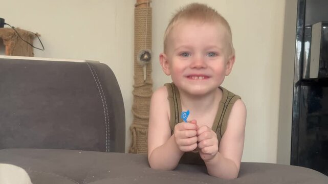 Video: A 2-year-old boy sticks out his tongue. A 2-year-old boy looks at the camera