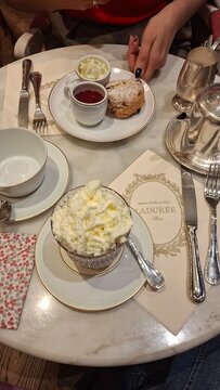 Elegant table layout with hot chocolate, tea and scone at Ladur&eacute;e
