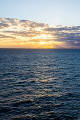 Fototapeta premium Calm ocean water skyline at sunset tranquil seascape vertical photo