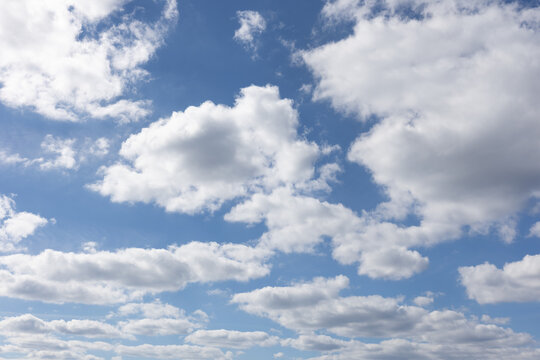 Photo of beautiful soft white cumulus clouds blue sky sun back lighting clouds.