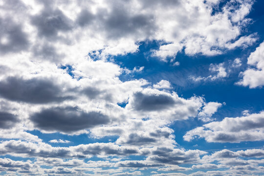High resolution photo of vibrant blue sky and white fluffy clouds beautiful background and texture resource.