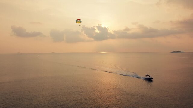 Stunning parasailing adventure over vast ocean waters at golden hour