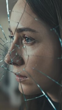 Woman Looks Into a Cracked Mirror Reflection