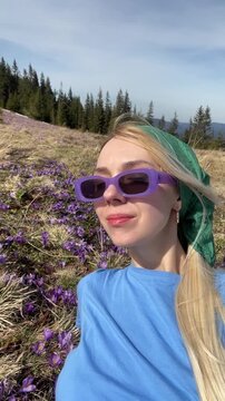 Beautiful tourist woman makes selfie in the mountains