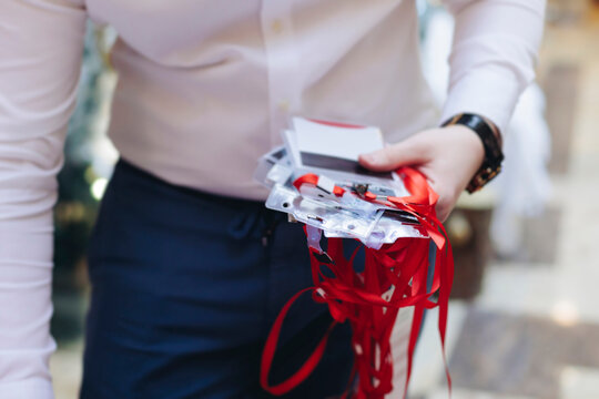 Checking in on conference congress forum event, registration desk table, visitors and attendees register electronic ticket and receiving red lanyard with name badge and entry wristband bracelet