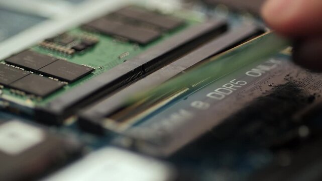 Inserting memory module into DIMM slot on laptop motherboard