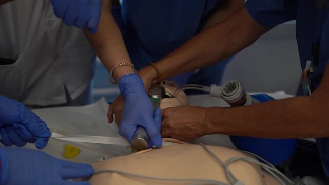 Paramedics in training practicing airway management and resuscitation techniques on a medical dummy