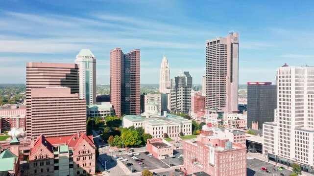 Aerial revealing shot of the Ohio State House and Columbus skyline with slow camera approach towards the Capitol