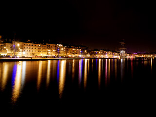 Obraz premium Caen city lights reflecting on harbor water at night