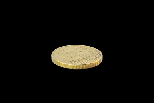 Side-angle view of a 50-cent Euro coin's reverse. Features the face value and European map on a golden-toned Nordic gold surface, isolated on a plain transparent black background.