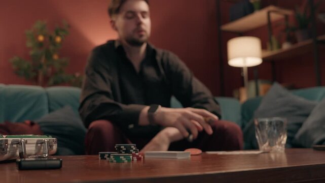 Sad frustrated Caucasian male gambler losing poker game smoking cigar at home man guy player playing cards lost blackjack defeat competition upset stressed gamer betting wager gambling addict failure