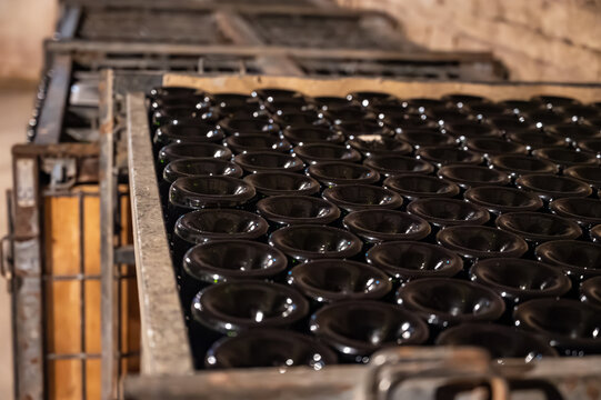 Visit of underground caves at Champagne producers, houses, fermentation and aging, riddling, process of making champagne sparkling wine in Champagne region in France