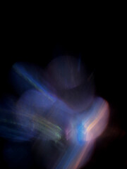 A blurry image of a purple and blue light with a dark background. The light is in the center of the image and is surrounded by a blurry purple and blue area. Light leak for design and special effects. © mark_gusev