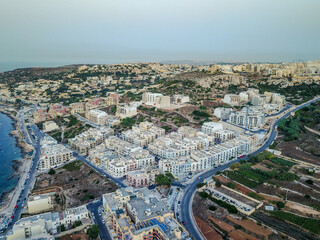 Fototapeta premium Sunset Aerial of Mellieħa Town with Partial Coastline in Malta