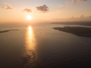 Fototapeta premium Aerial Sunset View of Malta–Gozo Ferry Passage with Comino, Malta