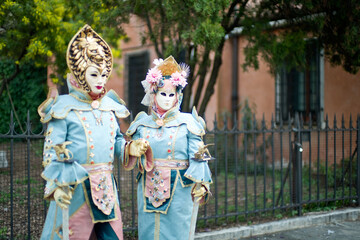 Obraz premium Venice, Italy - February 9, 2026 - People dressed in masks for the Venice Carnival have their photos taken by tourists