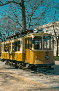 Tram passing through Cl&eacute;rigos area in Porto, with Cl&eacute;rigos Tower visible in the background.
