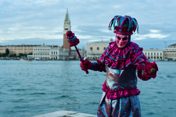 Obraz premium Venice, Italy - February 9, 2026 - People dressed in masks for the Venice Carnival have their photos taken by tourists