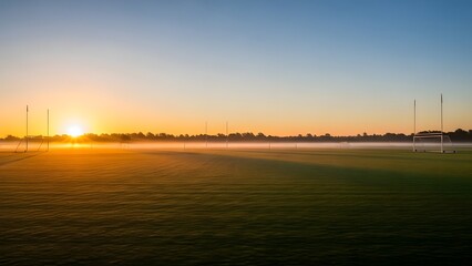 Sunrise Over A Sports Field With Goalposts.