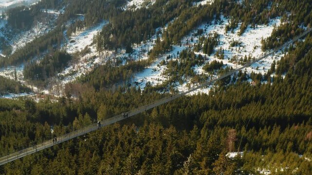 Sky Bridge 721 suspension footbridge connecting two hills above a forest landscape in Dolni Morava, Czech Republic. Concept of tourism and outdoor exploration.