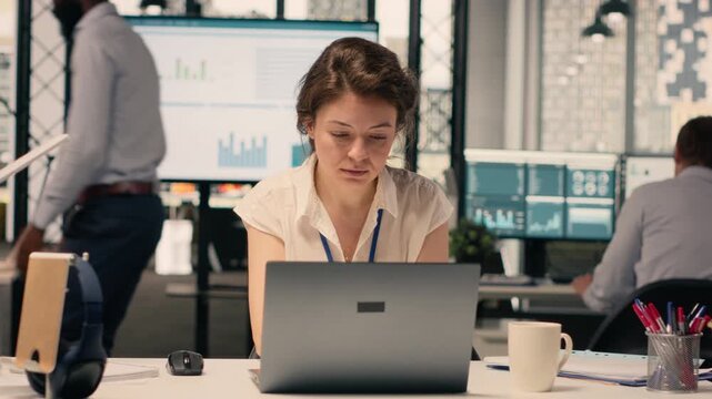 Portrait businesswoman, data analysis, forecasting reports, corporate office. Laptop with charts, KPI metrics, supporting business development, productivity, global business, strategy.