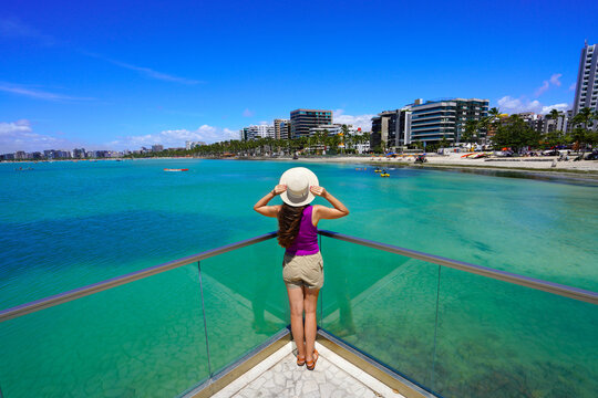 Holidays in Brazilian Caribbean. Full length of young traveler woman on belvedere in the city of Maceio, Alagoas, Brazil.