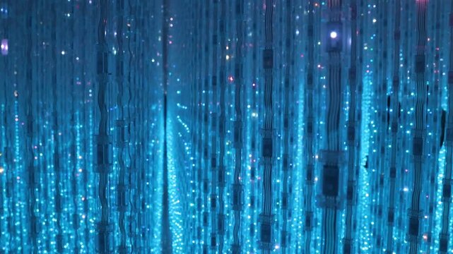 Beautiful lighting artwork with lighting Hundreds of strings of LED lights are hung from the ceiling of mirrored infinity room