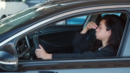 Busy female in automobile ready to drive