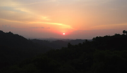 Obraz premium Majestic sunset horizon glowing softly above jungle
