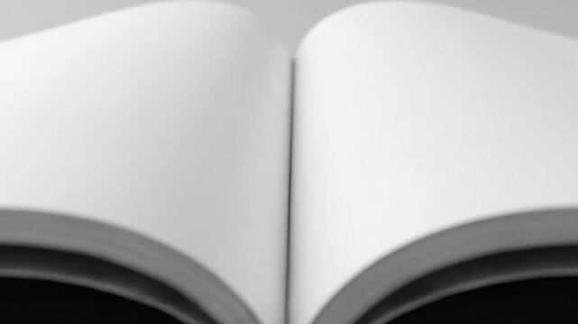Blank Pages Reveal: Minimalist Video of an Open Magazine with Empty White Sheets and Shadow Play