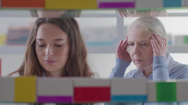 Smiling Pharmacist Advising Senior Woman on Headache Relief Pills in Modern Pharmacy