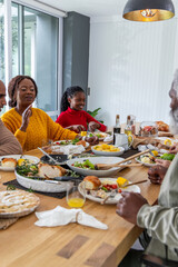 African American family sharing food at large wooden dining table with pie and orange juice © wavebreak3