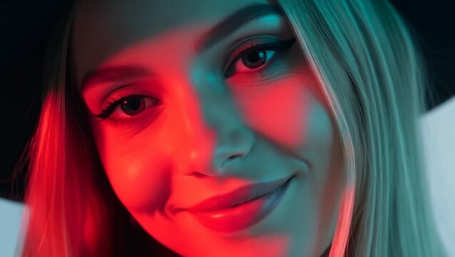 Stylish Young Woman With Hat Poses With Red and Blue Neon Lighting, Close-Up Portrait