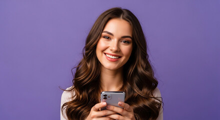 Fototapeta premium Smiling young woman with long brown hair using smartphone