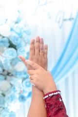 Couple's romantic wedding moment with intertwined hands and gold rings