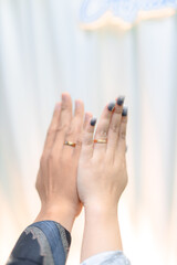 Couple's hands with wedding rings and manicured nails