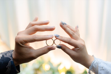 Couple exchanging wedding rings in romantic gesture