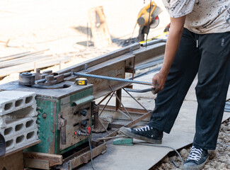 Heavy-duty automatic steel bar bender for concrete reinforcement in building construction.