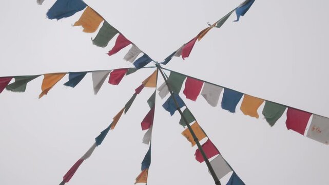 Prayer flags are strung up on a hilltop in Sapa, L&agrave;o Cai, Vietnam, to spread positive energy and good fortune. The flags are colorful and vibrant, even in the thick fog.