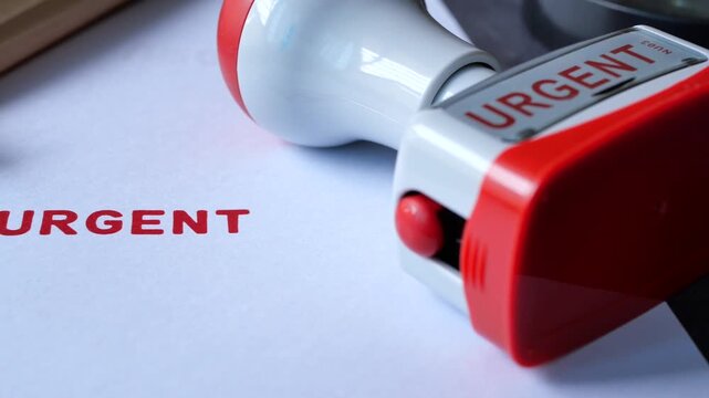 Close up of urgent stamp on paper and pencil, office supplies, document marking