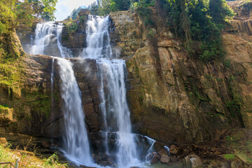 Fototapeta premium Ramboda Falls Cascading Over Rocky Cliff in the Central Highlands of Sri Lanka