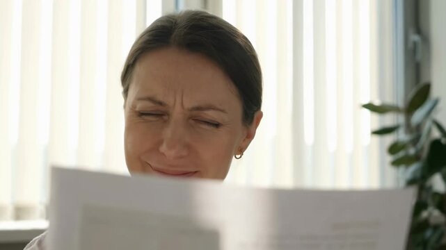 Presbyopia woman stress fatigue focus concept. presbyopia woman stress fatigue focus mature female face closeup squint eye indoor office light vision