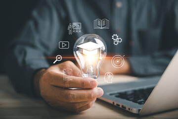 E learning, innovation, skill, idea, creativity, knowledge concepts show as a hand holds bulb with...