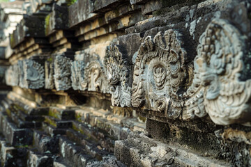 Obraz premium Intricate stone carvings decorate an ancient temple wall, showcasing detailed craftsmanship and weathered textures.