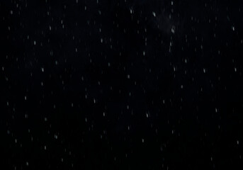 Obraz premium Distant silver specks floating across deep indigo expanse, haze hinting at faraway clouds, atmospheric texture for cosmic themed visuals high