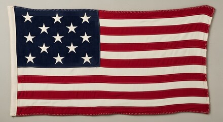 Fototapeta premium Embroidered version of the american flag with fifty white stars on blue canton. 13 colonies flag
